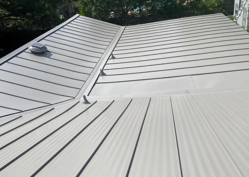 Solar attic fan installed on a metal roof for Roof Ventilation in Horseshoe Bay