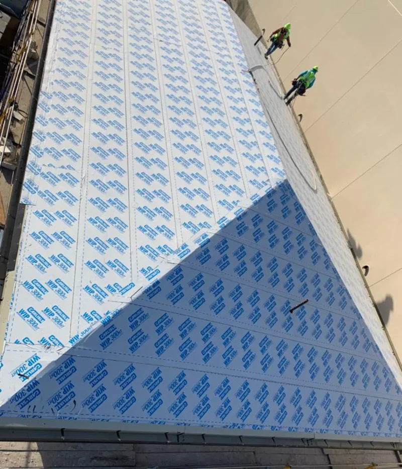 Professional roofers installing underlayment on a metal roof in Horseshoe Bay